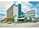 Attractive Landmark Resort building with palm trees and well-maintained landscaping at 1501 S Ocean Blvd. # 1232, Myrtle Beach, SC 29577