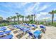 Sunny outdoor lounge area with blue chairs and umbrellas, overlooking the beach and ocean at 1501 S Ocean Blvd. # 1232, Myrtle Beach, SC 29577
