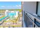 View from the balcony shows a distant waterpark and lush landscaping at 1501 S Ocean Blvd. # 1410, Myrtle Beach, SC 29577