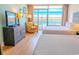 Bright bedroom boasts two beds and a cozy armchair next to a large window at 1501 S Ocean Blvd. # 1410, Myrtle Beach, SC 29577