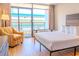 Cozy bedroom featuring a comfortable bed, a bright window to the balcony, and a cozy chair at 1501 S Ocean Blvd. # 1410, Myrtle Beach, SC 29577