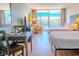 Comfortable bedroom featuring two beds, a desk, and a view of the balcony at 1501 S Ocean Blvd. # 1410, Myrtle Beach, SC 29577