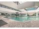 Indoor pool with a fountain feature, surrounded by lounge chairs and a brick-paved deck at 1501 S Ocean Blvd. # 1410, Myrtle Beach, SC 29577