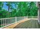 Enjoy the outdoors on this spacious wooden deck with views of lush greenery at 1673 Carriage Ln., Little River, SC 29566