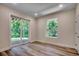 Basement room with natural light, a glass door providing easy outdoor access and durable flooring at 1673 Carriage Ln., Little River, SC 29566
