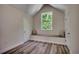 Bright bedroom space with wood floors, a cushioned window bench, and natural light at 1673 Carriage Ln., Little River, SC 29566