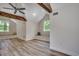 Well-lit bonus room featuring vaulted ceilings, rustic wooden beams, and charming window seats at 1673 Carriage Ln., Little River, SC 29566