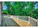 Large wooden deck overlooking a lush green backyard, ideal for enjoying nature at 1673 Carriage Ln., Little River, SC 29566