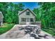 Inviting home with a spacious driveway, lush greenery, and light green siding at 1673 Carriage Ln., Little River, SC 29566