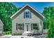 Charming home exterior featuring light green siding, black shutters, and a bright white front door at 1673 Carriage Ln., Little River, SC 29566