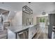 Modern kitchen featuring stainless steel appliances, a farmhouse sink, and an island with marble countertops at 1673 Carriage Ln., Little River, SC 29566