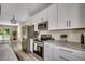 Well-appointed kitchen featuring stainless steel appliances, white cabinets, and stone countertops at 1673 Carriage Ln., Little River, SC 29566