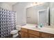 Bathroom includes toilet, vanity with sink, mirror and shower with a patterned shower curtain at 2029 Silvercrest Dr. # 22B, Myrtle Beach, SC 29579