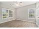 This bright bedroom has two windows and wood-look flooring at 2029 Silvercrest Dr. # 22B, Myrtle Beach, SC 29579