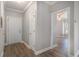 Hallway leading to the living areas featuring hardwood floors, neutral paint, and white trim at 2029 Silvercrest Dr. # 22B, Myrtle Beach, SC 29579