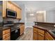 Well-lit kitchen featuring stainless steel appliances, wood cabinets and modern countertops at 2029 Silvercrest Dr. # 22B, Myrtle Beach, SC 29579