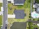 Aerial view of a home with a pool, landscaping, pond, and a driveway at 205 Marsh Deer Place, Surfside Beach, SC 29575