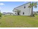 Large backyard featuring a covered patio and lush green lawn at 205 Marsh Deer Place, Surfside Beach, SC 29575