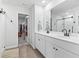 Bright bathroom with a double vanity, a large mirror, and a glass enclosed shower, complemented by a walk in closet at 205 Marsh Deer Place, Surfside Beach, SC 29575