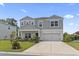 Two story home with grey shingle and white siding, landscaped yard and two car garage at 205 Marsh Deer Place, Surfside Beach, SC 29575