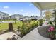 View from the porch highlighting the meticulously landscaped front yard and the neighborhood at 205 Marsh Deer Place, Surfside Beach, SC 29575