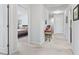 Neutral hallway with view into a bedroom with a blue bed frame and an adjacent doorway at 205 Marsh Deer Place, Surfside Beach, SC 29575