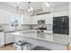Bright kitchen with granite countertops, stainless appliances, and a 