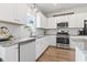 Bright kitchen with white cabinets, stainless steel appliances, and granite countertops at 205 Marsh Deer Place, Surfside Beach, SC 29575