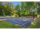 Community basketball court surrounded by lush trees and white picket fence at 2072 Haystack Way, Myrtle Beach, SC 29579