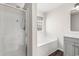 Bathroom featuring glass shower, soaking tub, grey vanity, and a window at 2072 Haystack Way, Myrtle Beach, SC 29579