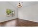 Dining area featuring wood floors, a modern chandelier, and a bright window overlooking the yard at 2072 Haystack Way, Myrtle Beach, SC 29579