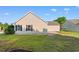Tan siding with black shutters compliment the manicured lawn and exterior of this home at 2072 Haystack Way, Myrtle Beach, SC 29579