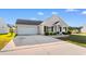 Inviting home with a spacious driveway, well-kept lawn, and charming curb appeal with black shuttered windows at 2072 Haystack Way, Myrtle Beach, SC 29579