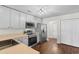 Functional kitchen featuring stainless steel appliances, white cabinets, and wood-look flooring at 2072 Haystack Way, Myrtle Beach, SC 29579