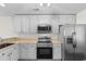 Bright kitchen featuring white cabinets, stainless steel appliances, and ample countertop space at 2072 Haystack Way, Myrtle Beach, SC 29579