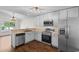 Modern kitchen with stainless steel appliances, white cabinets, and wood flooring at 2072 Haystack Way, Myrtle Beach, SC 29579