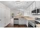 Open kitchen layout with stainless steel appliances, white cabinets, and access to the dining and living area at 2072 Haystack Way, Myrtle Beach, SC 29579