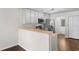 Well-lit kitchen featuring white cabinetry, stainless steel appliances, and a breakfast bar for casual dining at 2072 Haystack Way, Myrtle Beach, SC 29579