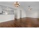Spacious living room with vaulted ceilings, dark wood floors, chandelier, and easy access to the kitchen at 2072 Haystack Way, Myrtle Beach, SC 29579
