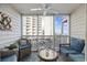 Relax on this screened in balcony with a sofa and chair with ocean views in the background at 210 N Ocean Blvd. # 333, North Myrtle Beach, SC 29582