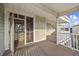 A private condo balcony with seating, showing covered walkway and partial view at 210 N Ocean Blvd. # 333, North Myrtle Beach, SC 29582