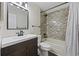 Bathroom featuring a modern vanity, toilet, and tub/shower combination with a marble-look surround at 210 N Ocean Blvd. # 333, North Myrtle Beach, SC 29582