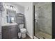 Bathroom featuring a dark vanity, walk-in shower with marble-look surround, and a chrome framed mirror at 210 N Ocean Blvd. # 333, North Myrtle Beach, SC 29582