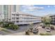 Coastal condo building with ample parking and white balconies near the beach at 210 N Ocean Blvd. # 333, North Myrtle Beach, SC 29582