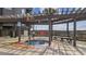 Outdoor hot tub under a pergola with wooden benches, providing a relaxing space at 210 N Ocean Blvd. # 333, North Myrtle Beach, SC 29582