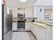 Bright kitchen with stainless steel appliances, white cabinets, and tile flooring at 210 N Ocean Blvd. # 333, North Myrtle Beach, SC 29582