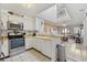 A well-lit kitchen with stainless steel appliances and an adjacent breakfast bar at 210 N Ocean Blvd. # 333, North Myrtle Beach, SC 29582