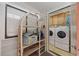 Bright condo laundry room with washer, dryer, and convenient shelving at 210 N Ocean Blvd. # 333, North Myrtle Beach, SC 29582