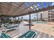 Relaxing pool deck area featuring a hot tub, lounge chairs, and a covered pergola for shade and comfort at 210 N Ocean Blvd. # 333, North Myrtle Beach, SC 29582