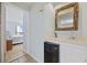 Wet bar featuring a sink, countertop, mini fridge and a driftwood-framed mirror at 210 N Ocean Blvd. # 333, North Myrtle Beach, SC 29582